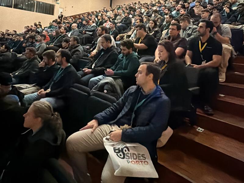 Packed auditorium of security professionals at BSides Porto